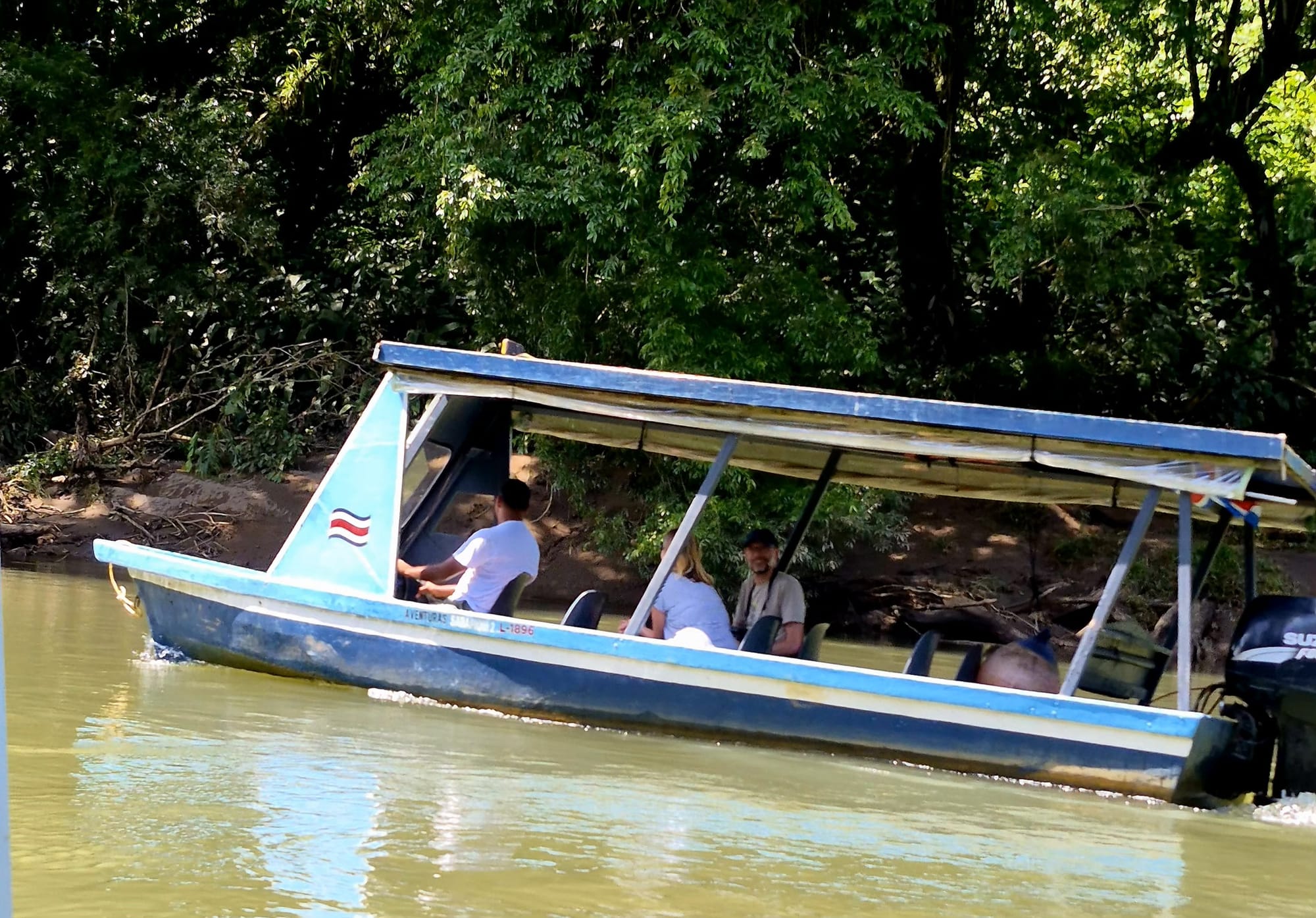 Covered river boat used for our Sarapiquí River day trip — a stable, shaded vessel ideal for wildlife spotting and cruising quietly through the rainforest.