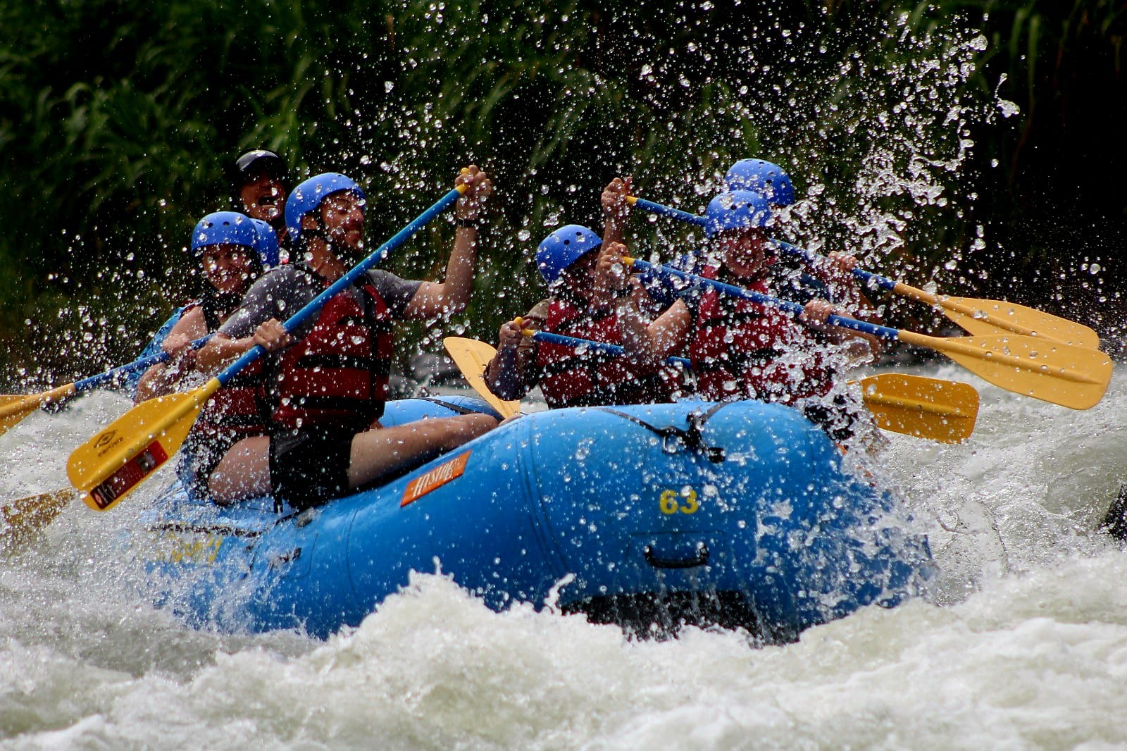 Good timing and steady strokes keeping the raft on line through the rapid.